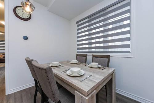 a dining room with a wooden table and chairs at Spacious 4br25ba Retreat W King Beds, Desk, Dt in Milton