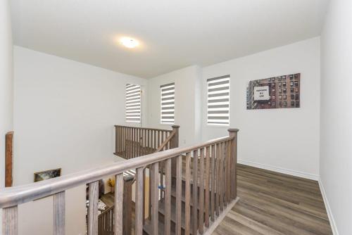 a staircase in a home with white walls and wood floors at Spacious 4br25ba Retreat W King Beds, Desk, Dt in Milton