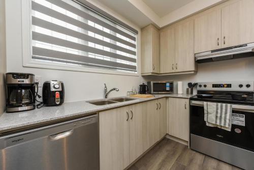 a kitchen with a sink and a stove at Spacious 4br25ba Retreat W King Beds, Desk, Dt in Milton