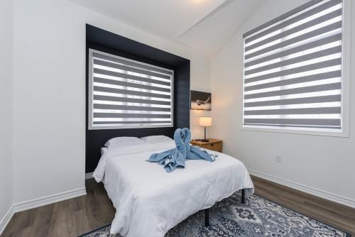 a bedroom with a bed with a blue bow on it at Spacious 4br25ba Retreat W King Beds, Desk, Dt in Milton