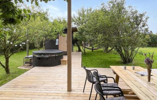 a patio with a table and chairs and a grill at Gorgeous Home In Tarm With Sauna in Tarm