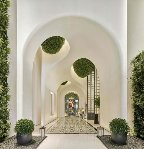 a hallway with an archway with potted plants at Shangri-La Nanshan, Shenzhen, Stay for 2 consecutive nights and enjoy breakfast in Shenzhen