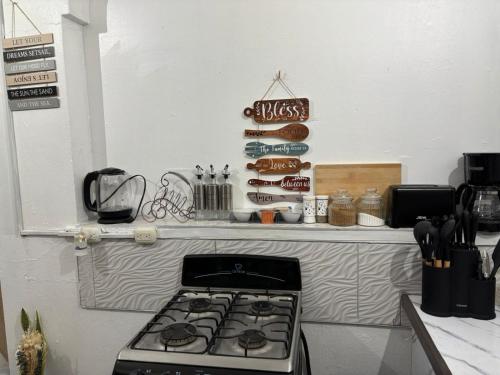 a stove top in a kitchen with a counter top at Villa Solara Your Spacious, Central, Affordable Stay in Kingston in Kingston