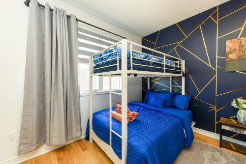 a bedroom with two bunk beds and blue walls at Brand New 7beds-kingbedsfamilysleep15playtable in Milton