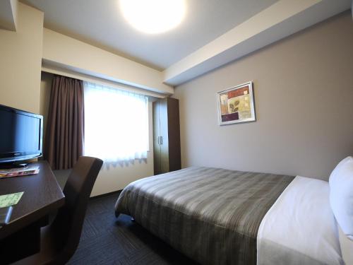 Postel nebo postele na pokoji v ubytování Hotel Route-Inn Satsumasendai