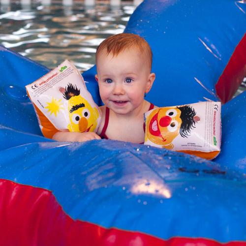 a baby in the water with a book at Buitenplaats Gerner in Dalfsen