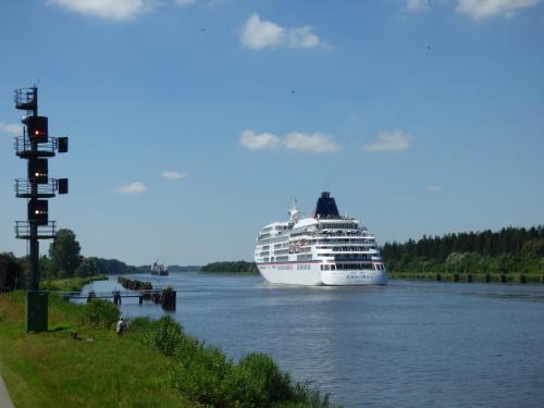 a cruise ship is docked in a river at Kanalkajüte Theodor in Hanerau-Hademarschen