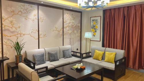 a living room with a couch and a table at GreenTree Inn Express Datong High-Speed Railway Station Wanda Plaza Fangte in Datong