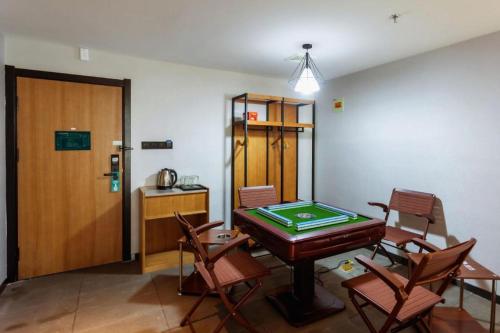 a room with a ping pong table and chairs at GreenTree Inn Express Datong High-Speed Railway Station Wanda Plaza Fangte in Datong