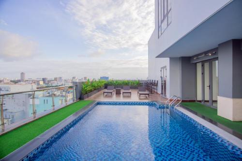 a swimming pool on the roof of a building at Quoc Cuong Hotel & Apartment Danang by Haviland in Da Nang