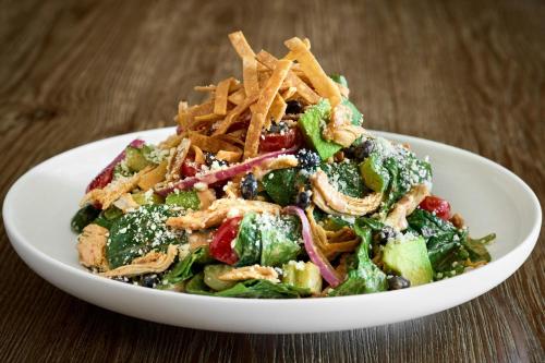 a salad in a white bowl on a wooden table at JW Marriott Washington, DC in Washington
