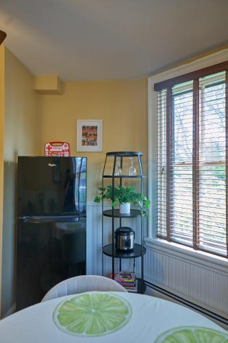 a room with a table and a tv and a window at The Underwood-Hale House in Providence