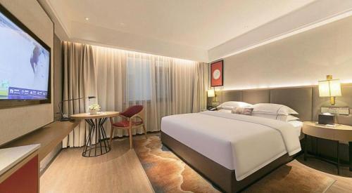 Ένα ή περισσότερα κρεβάτια σε δωμάτιο στο Echeng Hotel Enshi Minzu Road