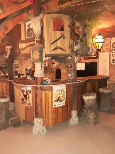 a room with a bar in a log cabin at สบายคันทรีรีสอร์ท ปากเมงSa-buy country resort Pak Meng in Sikao