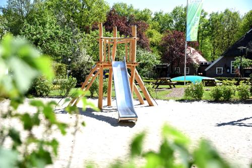 a playground with a slide in the sand at Buitenplaats Gerner in Dalfsen