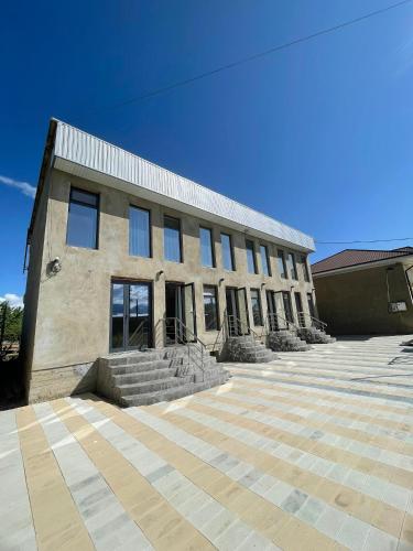 a large building with steps in front of it at Mountain View in Kochkor