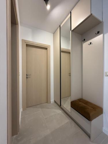 a walk in closet with a door and a mirror at APARTTLu in Kotor