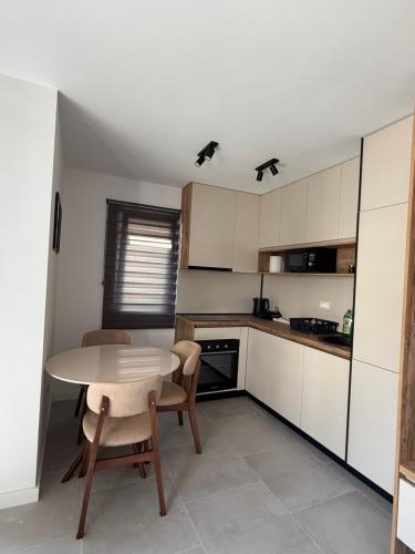 a small kitchen with a table and chairs in it at APARTTLu in Kotor