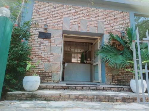 a brick building with a door and a window at The Coastal Hotel in Trincomalee