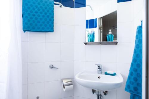 a white bathroom with a sink and a mirror at Albert Court in Liverpool in Liverpool