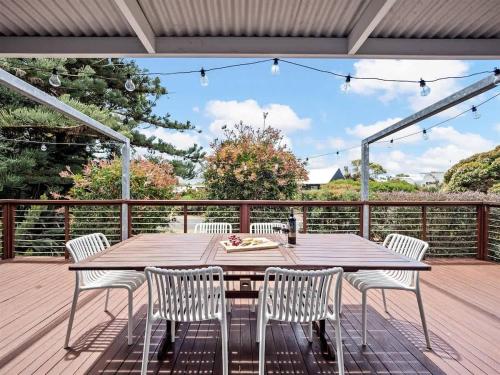 a wooden table and chairs on a deck at Eagle Bay Beach House - 300m to the beach! in Dunsborough