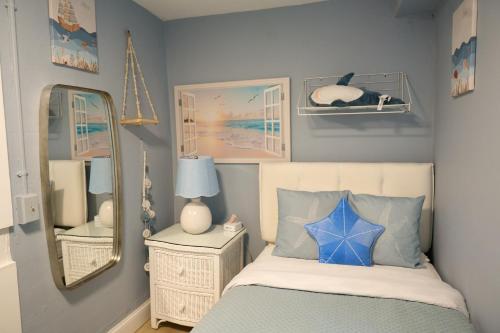 a bedroom with a bed and a mirror at The Underwood-Hale House in Providence