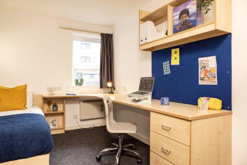 a bedroom with a bed and a desk with a computer at Albert Court in Liverpool in Liverpool
