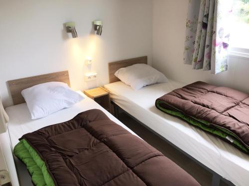 Ένα ή περισσότερα κρεβάτια σε δωμάτιο στο O2 Camping