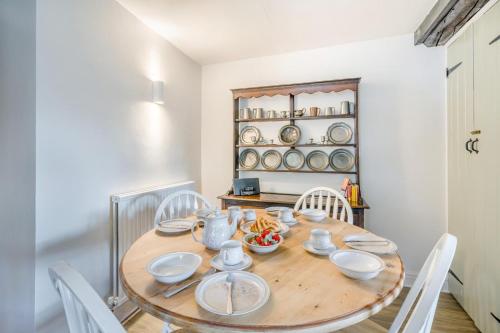 a dining room with a wooden table and white chairs at 2 Bed in Brough oc-c31900 in Brough