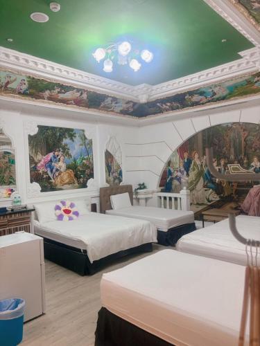 a bedroom with two beds and a painting on the ceiling at Good 9 Stay Inn in Taipei