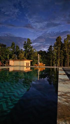 a large pool of water in front of a building at Hideaway By Aahma in Rāmnagar