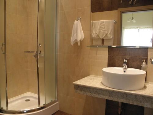 a bathroom with a sink and a shower at Anteya Serdika Apartments in Sozopol