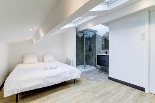 a white bedroom with a bed and a shower at La Cambuse - centre ville - 3 étoiles in Bourg-en-Bresse