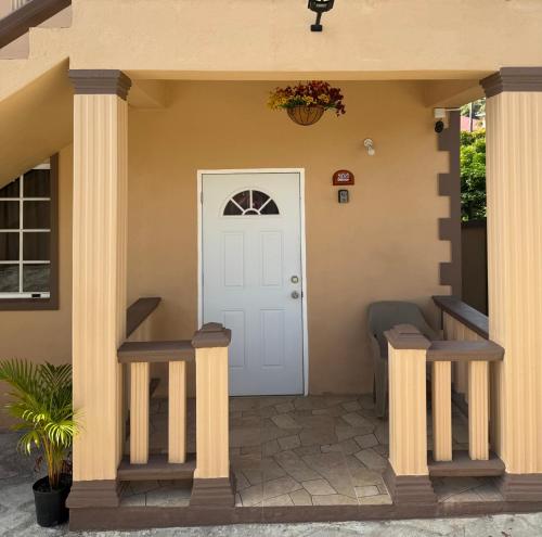 a front door of a house with columns at Castle Berry Apartments in Kingstown