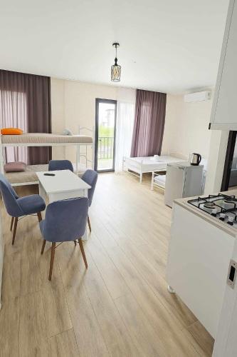 a kitchen and living room with a table and chairs at ilios in K'obulet'i