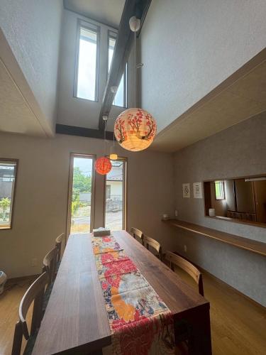 a dining room table with chairs and two lights at 日光萩垣面 Fabulous House 一棟貸 in Nikko