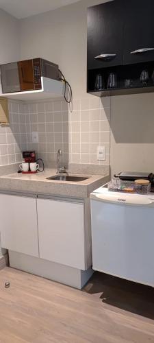 a kitchen with a sink and a counter top at STOP Mar Suite Privada - NI in Nova Iguaçu