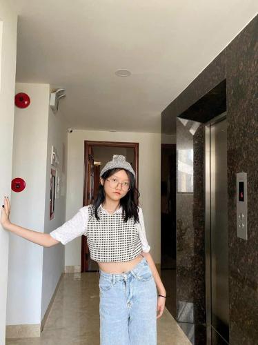 a woman wearing a hat standing in a hallway at Happy Beach Hotel in Nha Trang