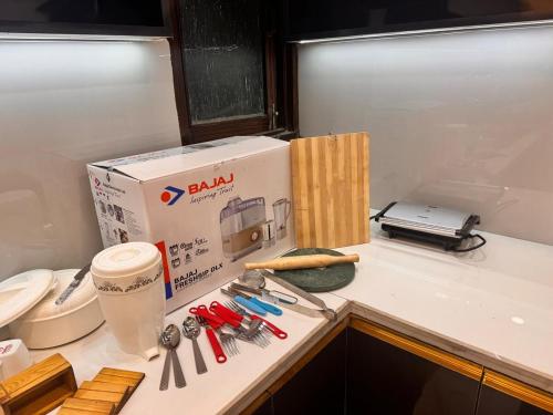 a box sitting on top of a kitchen counter with tools at YOUR BnB in Jāmb