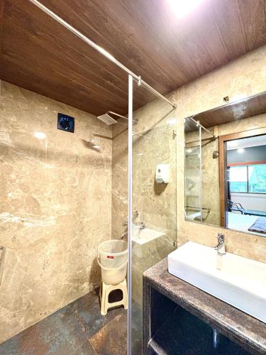 a bathroom with a sink and a toilet at HoneyBee Resort Lonavala in Lonavala