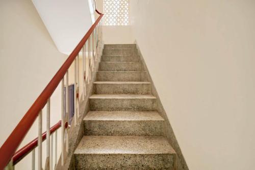 a staircase in a building with a stair case at Hotel O Sunrise in Dānāpur