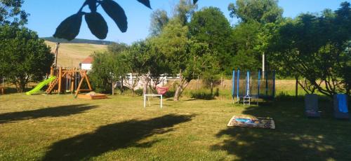 a yard with a playground and a swing set at KOÓS VENDÉGHÁZ in Uppony