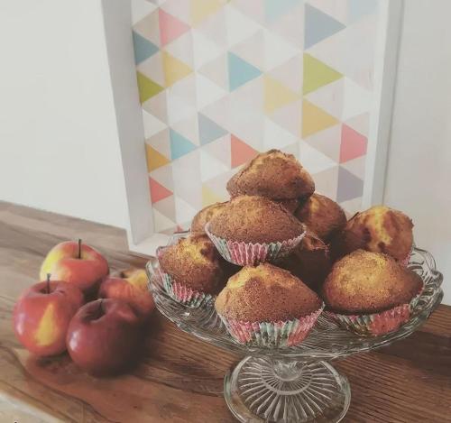 a bowl of muffins and apples on a table at Bed & Breakfast Ca' di Camineve in Loano