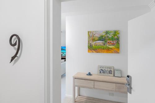 a room with a table and a painting on the wall at Rojo at Island Views—A Breezy Beachfront Retreat in Palm Cove
