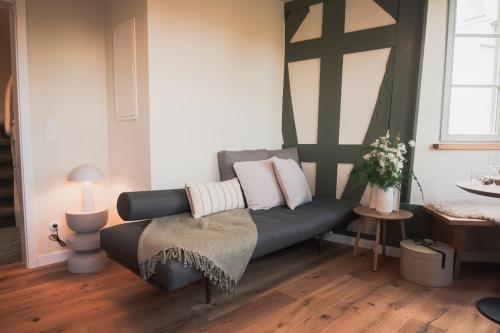 a living room with a couch with pillows on it at Übernachten im Wahrzeichen I Das Brückenhaus in Bad Kreuznach