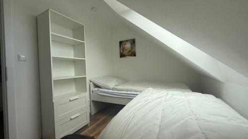 a small room with a bed and a closet at Ubytování U Kocábů in Drnholec