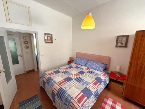 a small bedroom with a bed and a lamp at Historical Center with Garden "The Beach and The Cliff" 4 in Agropoli