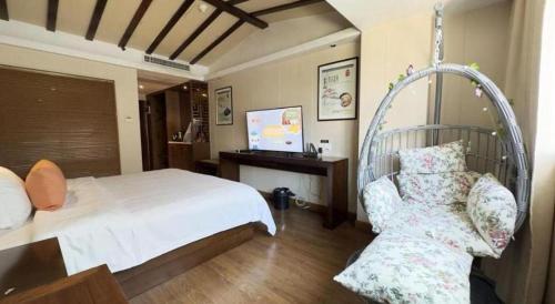 a bedroom with a white bed and a chair at Oriental Hotel in Dongguan