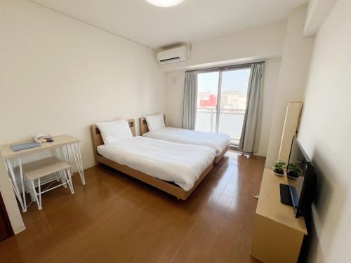 a small room with a bed and a window at CIEL BLEU in Tokyo