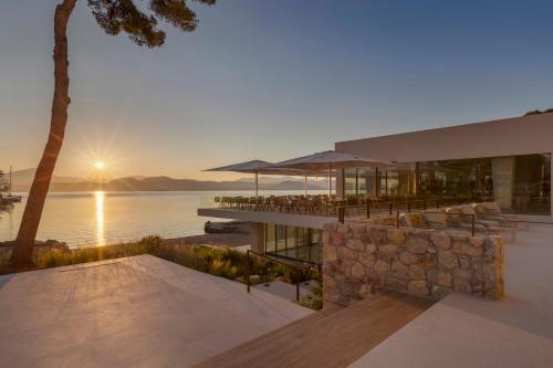 a rendering of a house with a view of the water at Mirage Chalkida City Resort in Chalkida